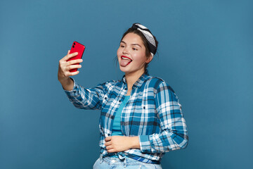 Happy Woman Making Selfie Smartphone. Plus Size Girl Showing Tongue While Videocalling Cellphone, Shooting Content For Social Media, Enjoying Mobile