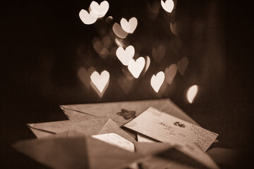 Valentines day letters, cards, glowing hearts in the dark, sepia effect