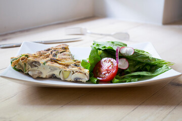Tortilla Española. Traditional Spanish omelette made with fried potato, onion and egg.