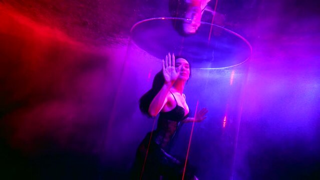 beautiful sexy woman with long black hair swimming slowly in depth of pool, fascinating underwater