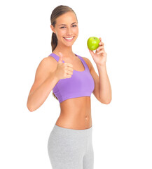 Woman, studio portrait and apple with thumbs up for health, diet goal or wellness by white background. Isolated model, healthy fruit or smile for nutrition, vitamin c or natural detox for strong body