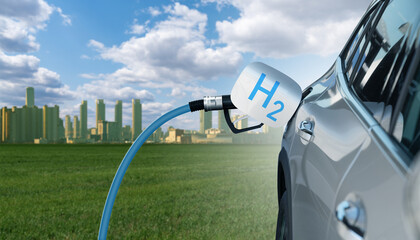 Fuel cell car with connected hydrogen fueling nozzle on a background of ecological green city	