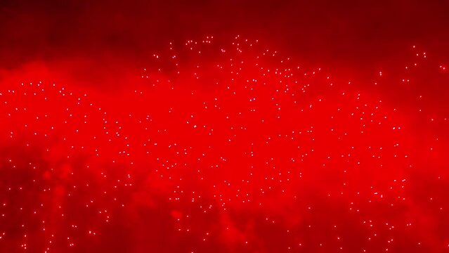 Colorful fireworks festival. Beautiful red fireworks close-up view in slow motion. Wonderful real fireworks in the night sky shot with a telephoto lens. fireworks show. 4K slow motion video.