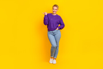 Fototapeta na wymiar Full length photo of cheerful satisfied person indicate thumb finger empty space isolated on yellow color background