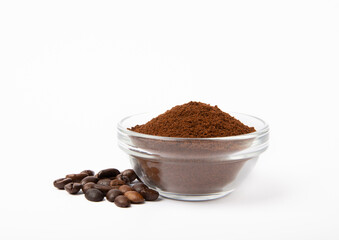 Ground coffee and beans in a bowl and loose isolated on a white background.