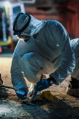 Forensics Expert Using Professional Equipment on Crime Scene to Retrieve Traces and Fingerprints....