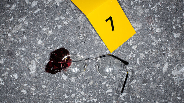 Realistic Police Case File Photo: Bloody Glasses Found on Crime Scene Marked as Evidence for a Suicide Case. Domestic Violence Led to a Dead Victim. Example of Forensics Photography