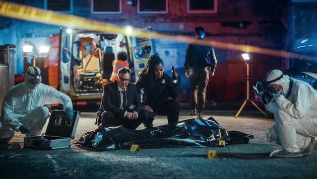 Crime Scene Investigators Developing Hypothesis on the Murder of a Young Man. Male Detective Suggesting Potential Mugging Gone Wrong. Policewoman Suggesting a Crime of Passion. They Check the Clues