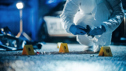 Forensics Specialists Starting to Pack Evidence on Crime Scene After a Tragic Ending of a Violent Gun Fire Exchange Between Gang Members. Empty Handgun is the Murder Weapon Used to Shoot the Victims - obrazy, fototapety, plakaty