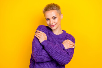 Fototapeta na wymiar Photo of young model blonde short hair embrace hugs her new favorite purple sweater fresh clothes after washing isolated on yellow color background