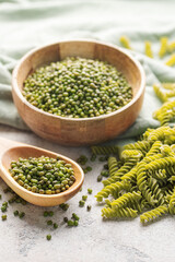 Mung bean fusilli pasta on a gray concrete background.