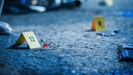 Close Up Low Angle Shot of Evidence Scattered at Crime Scene. Bloodied Glasses, Bloody Knife and...