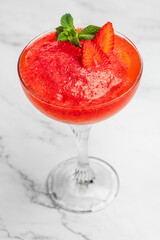 Frose cocktail mixed with strawberriess with pink wine. Alcoholic Beverage. Boozy Frozen Rose Frose