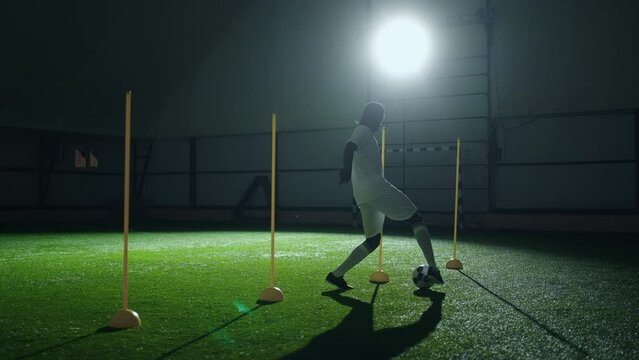active sportsman running in football training hall, african man training in night, future champion