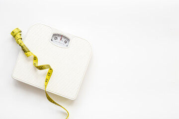 Weight scale and tape measure top view. Weight control concept