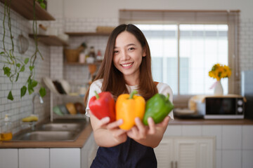 Portrait of beautiful young asian woman making salad at home. cooking food and Lifestyle moment