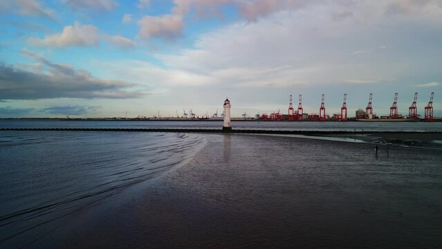 New Brighton Perch Rock Lighthouse, River Mersey, Wirral -  aerial drone low approach, Liverpool waterfront backdrop on a sunny winter afternoon(golden hour) 08.01.23