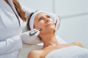 Woman in a beauty salon having needle mesotherapy treatment