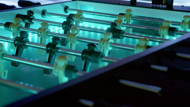 Slow pan of an led-backlit foosball table.  The futuristic setting is perfect for a sci-fi or spaceship setting.  A gorgeous club scene works as well to demonstrate fun ready to be had.