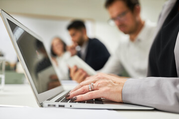 Hand von Business Frau beim Schreiben am Laptop