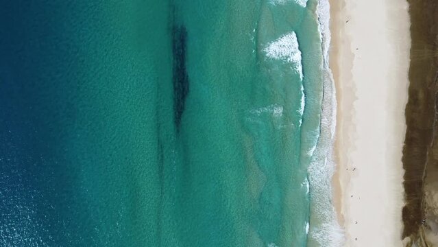 perfect turquoise water colors at the beach of tarifa in southern spain, from above with a drone