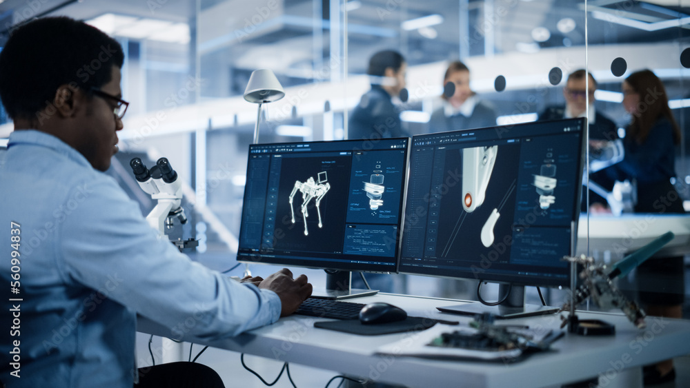 Aufkleber Black Robotics Engineer Working on Programming a Robot Dog on Desktop Computer. Young Team of International Industrial Science Specialists Developing a Mobile Robot in the Background.