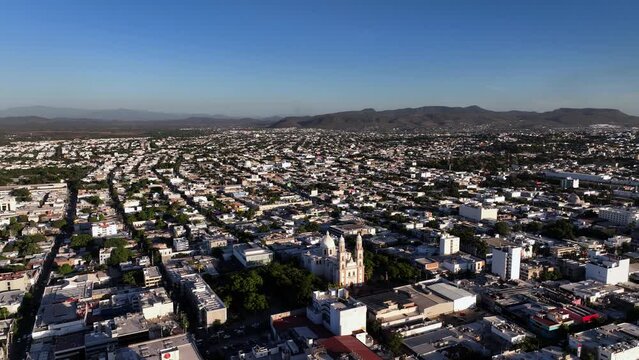 Aerial view overlooking the Basilica of Our Lady of the Rosary in Culiacan, in sunny Mexico - circling, drone shot