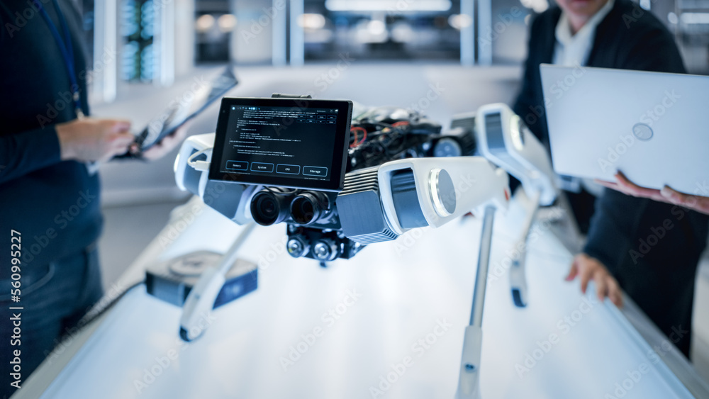 Poster Close Up Robot Dog Prototype with Smiling Emoji Face on Display Standing in a High Tech Modern Industrial Facility. Industrial Robotics Team Working on Scientific Industrial Technology Project.