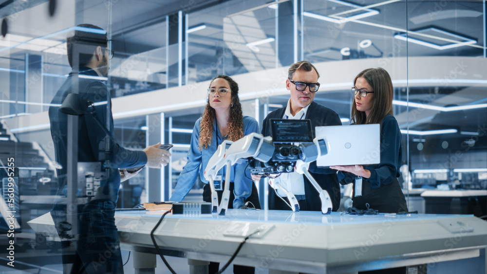 Poster Professional Multicultural Team of Female and Male Engineers Use Industrial Programmable Robot Animal in a Factory Development Workshop. Tech Facility with Machines, Computers and Research Equipment.