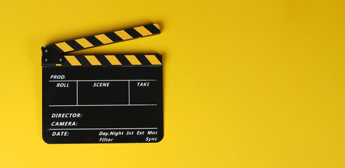 Yellow clapper board or movie slate on yellow background.