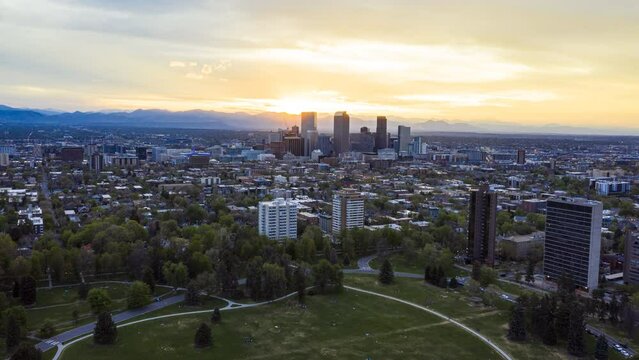 Aerial time lapse over Denver's Cheesman Park and surrounding residential area with the sun setting in the background.