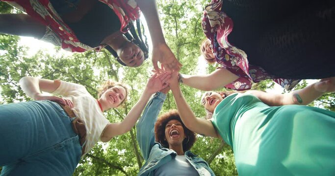 Diverse Group of Female Friends Stacking Their Hands Together as a Team and Ending with a Cheer. Multiethnic Girls Gathered in a Huddle to Motivate Eachother and Make a Plan