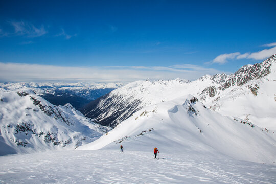 Skiers in a wide open landscape during the Spearhead Traverse in the Coast Mountains of British Columbia, Canada.