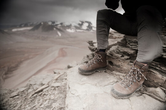 Close up of a mountaineers windblown legs as he  surveys Katmai Pass (830m) from the summit of Baked Mountain (1109m) Valley of Ten Thousand Smokes, Katmai National Park, Alaska, U