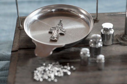Close-up of cross pendant on scales in workshop, Bavaria, Germany