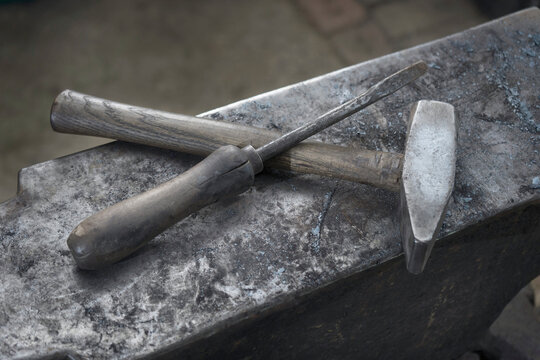 Hammer and screwdriver on anvil at blacksmith shop