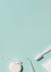 Dental care concept frame with toothbrush, tooth floss and toothpaste on the blue background. Copy...