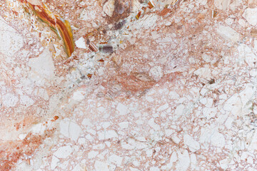 Texture of stone amalgam in orange and red tones.