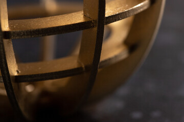 A wooden apple made of golden-colored slats