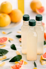 various salad vinegars in glass bottles. Front and top view. apple, lemon, strawberry, quince, grape, melon, apricot, tangerine, orange, grapefruit,
