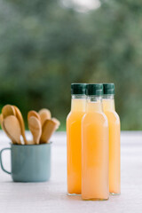 various salad vinegars in glass bottles. Front and top view. apple, lemon, strawberry, quince, grape, melon, apricot, tangerine, orange, grapefruit,