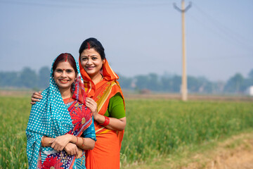 Indian rural woman’s in traditional saree at agriculture field.