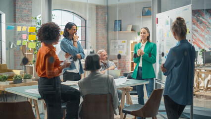 Female Business Coach for Company Management Explains How to Train your Team Efficiently in a Workshop Inside Creative Office. Woman Trainer Writing on Whiteboard and Training Interactive Employees - obrazy, fototapety, plakaty
