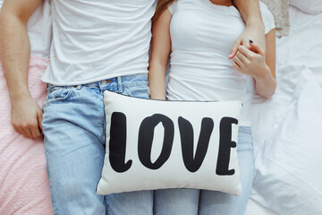 Cropped image of beautiful young couple at home. Hugging, kissing and enjoying spending time...