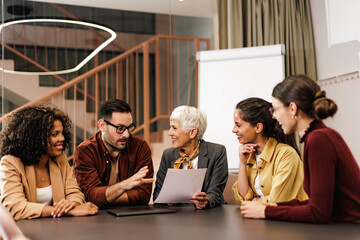 Businessman taking a word, talking, working with his female colleagues.