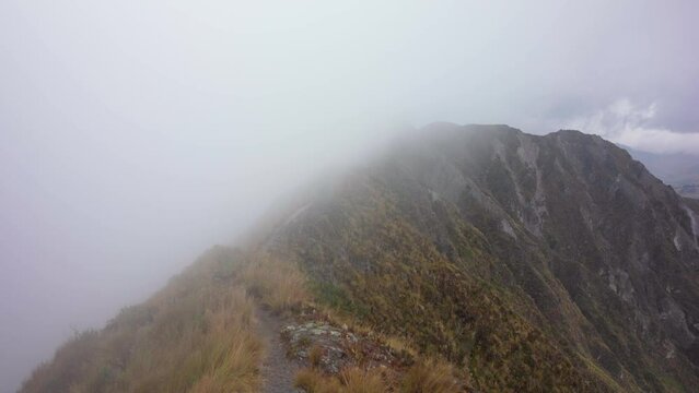 fog over the mountain near volcanic lake Quilotoa in Ecuador in South America