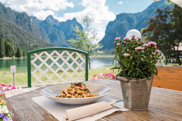 Amazing italian food ragu, ravioli at the lake lago di dobbiaco. Mountian food in the Dolomites Italy.
