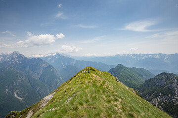 Young child boy hiker conquer the peaks of amazing mountain trail Monte Montusel in Friuli-Venezia Giulia, Italy