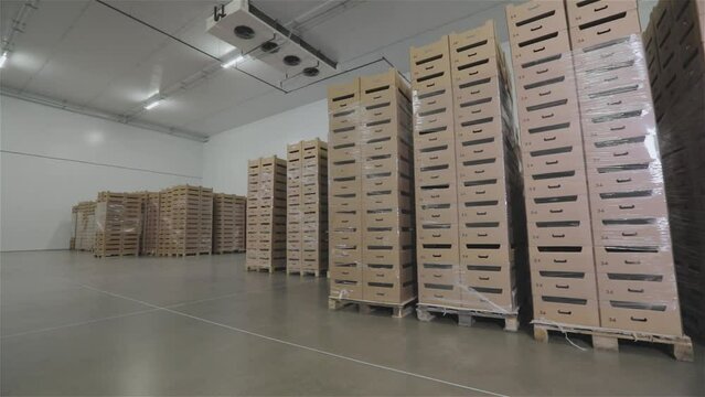 Boxes in a modern warehouse. Boxes in stock. A box of food in a warehouse. Modern warehouse with food products.
