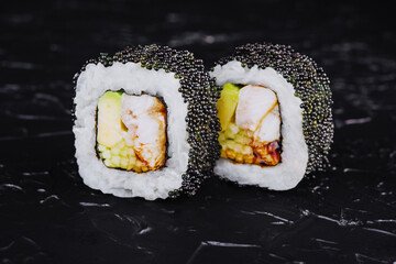 Sushi rolls with salmon, eel, cheese, avocado and black tobiko caviar